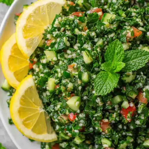Fresh tabbouleh salad with parsley, mint, tomatoes, and lemon garnish