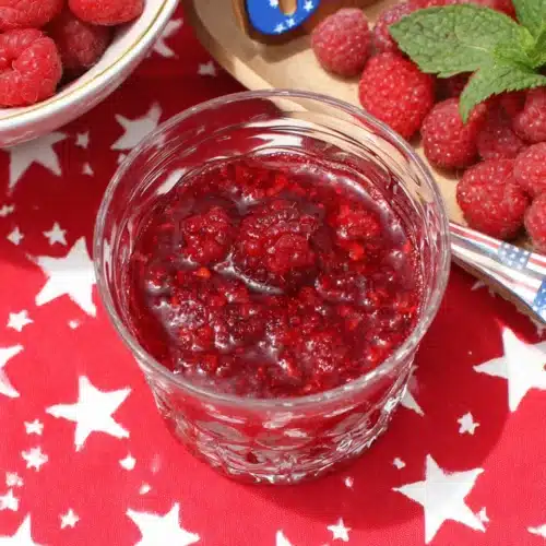 4th of July Mojito with fresh raspberries and festive red-white-star background
