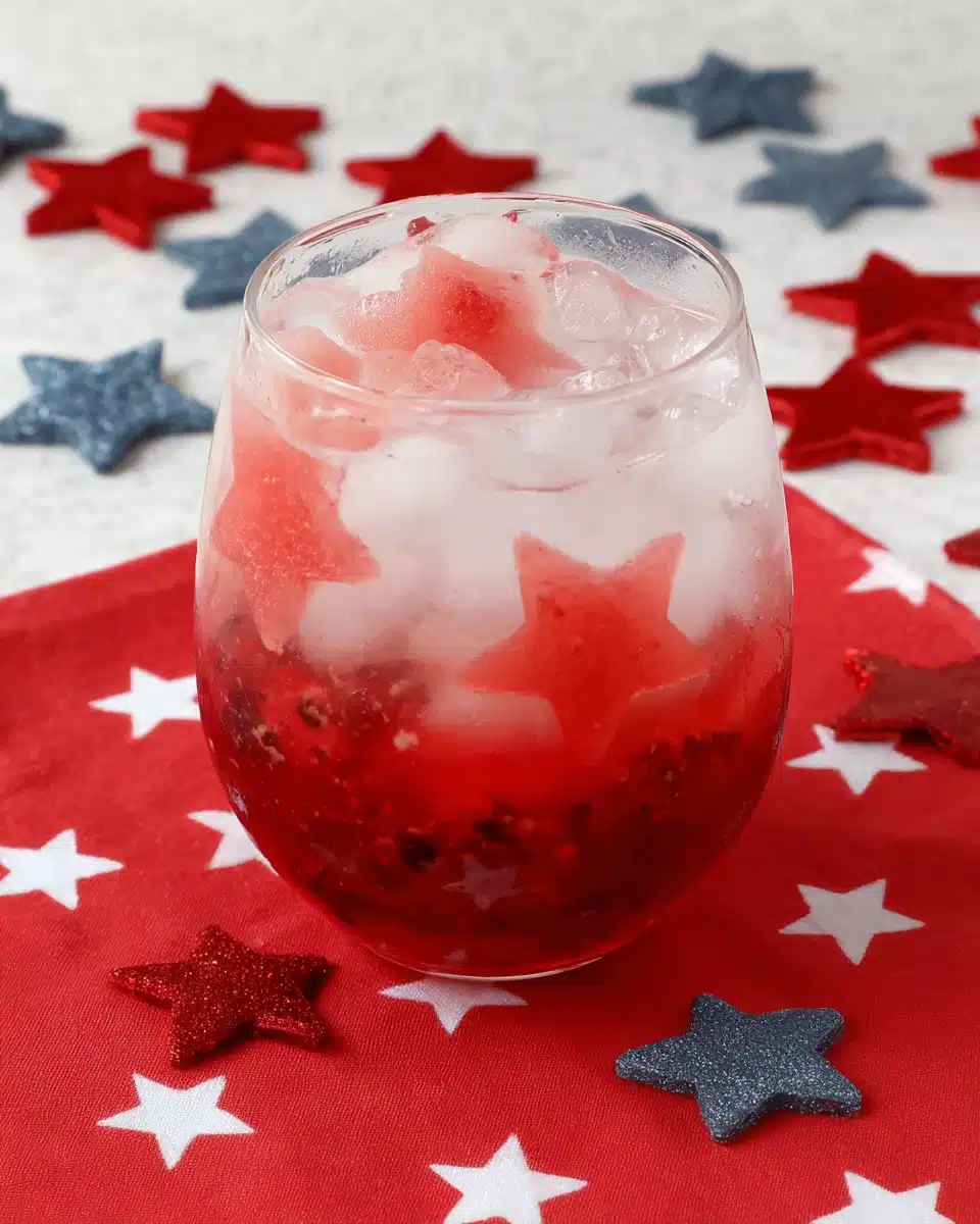 4th of July Mojito with red berry base and white fizz, served on a star-patterned cloth