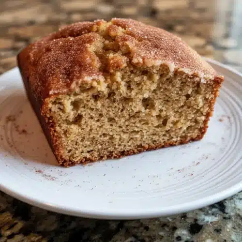 Cozy fall crockpot zucchini bread slice on a white plate
