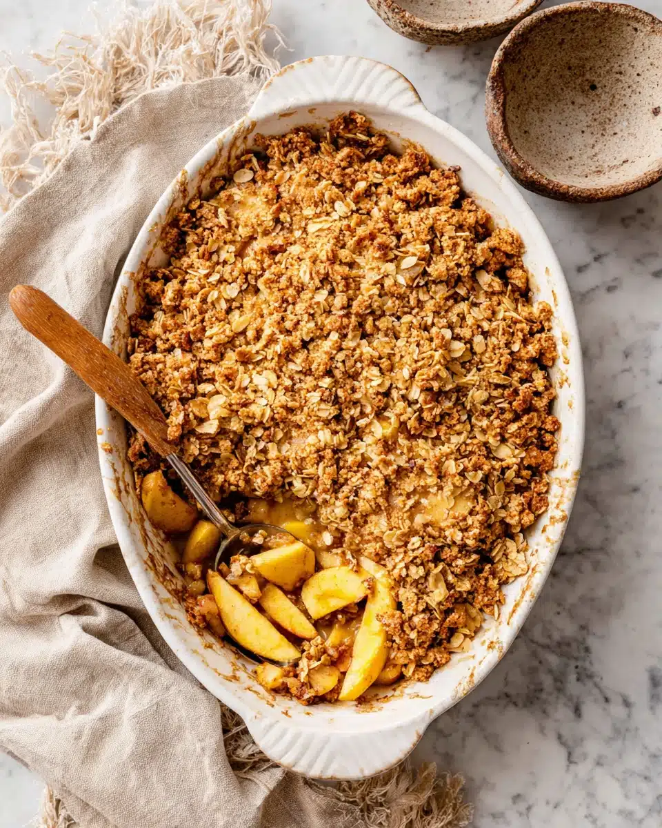 Crisp recipe: golden apple crisp with crumbly topping and juicy apples in a white dish