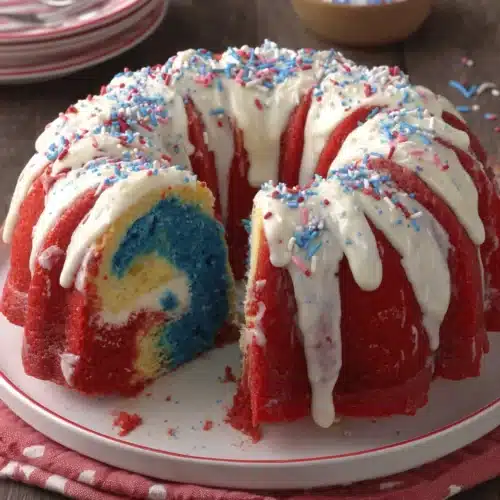Firecracker red, white and blue cake with colorful layers and drizzled frosting