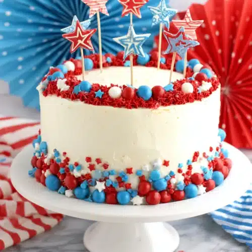 Fourth of July layer cake with red, white, and blue star decorations and candies