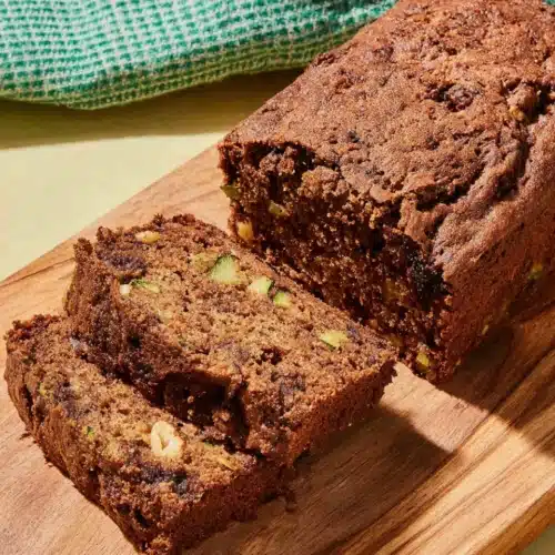 Gluten free chocolate zucchini bread with chocolate chips and walnuts on a wooden board