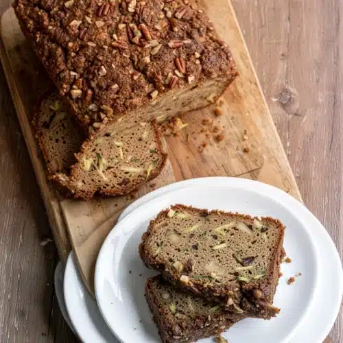 Zucchini Apple Bread Gluten Free – A Delightful Treat! 2 Gluten-free zucchini apple bread loaf with crumb topping and slices on wooden board