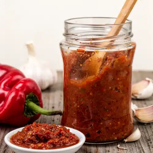 Homemade Hot Sauce Recipe: Spicy and Simple Delight 2 Homemade hot sauce in a glass jar with red peppers and garlic, vibrant and spicy