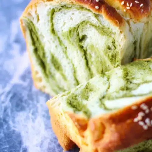 Sliced matcha and milk Japanese fluffy bread with green swirls and sesame seeds