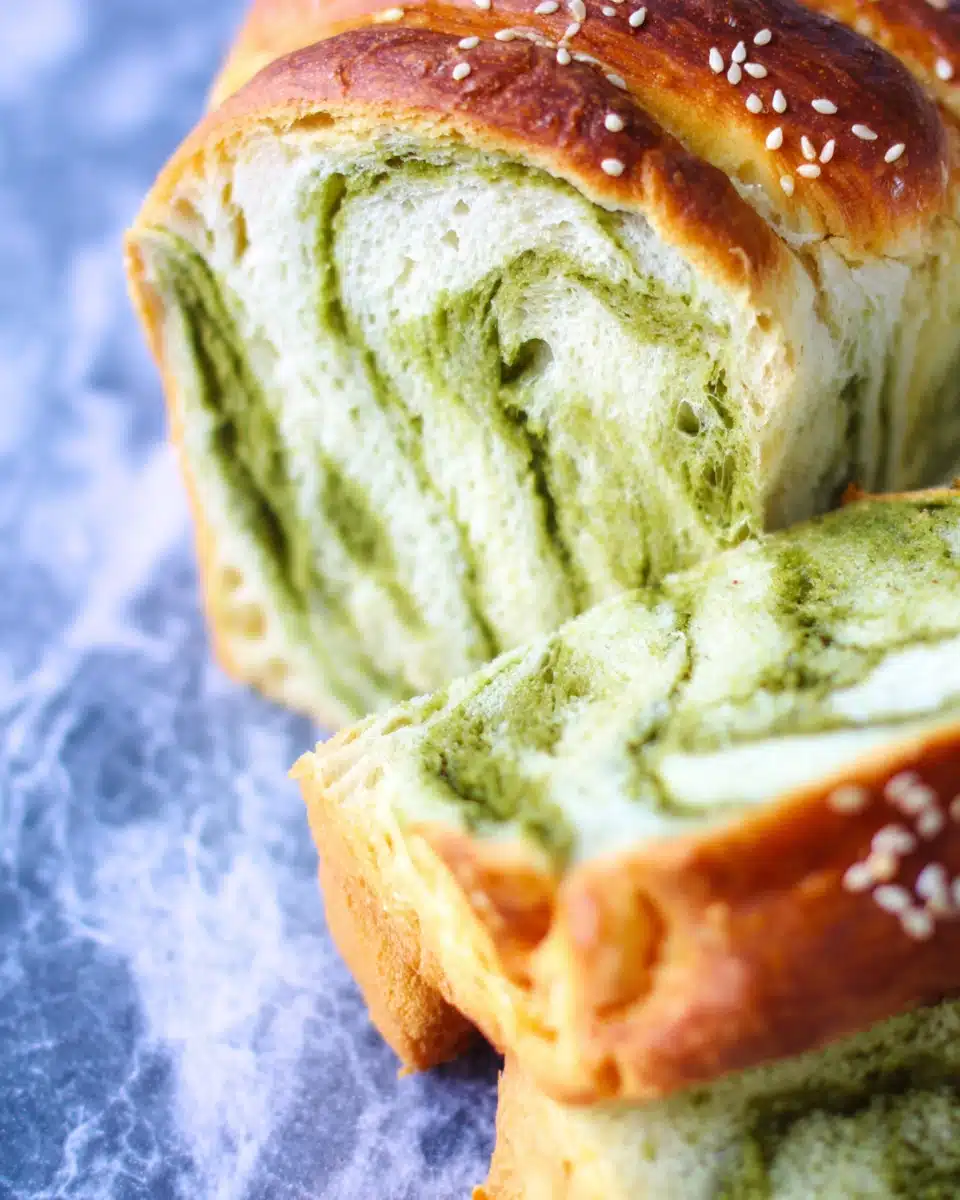 Sliced matcha and milk Japanese fluffy bread with green swirls and sesame seeds