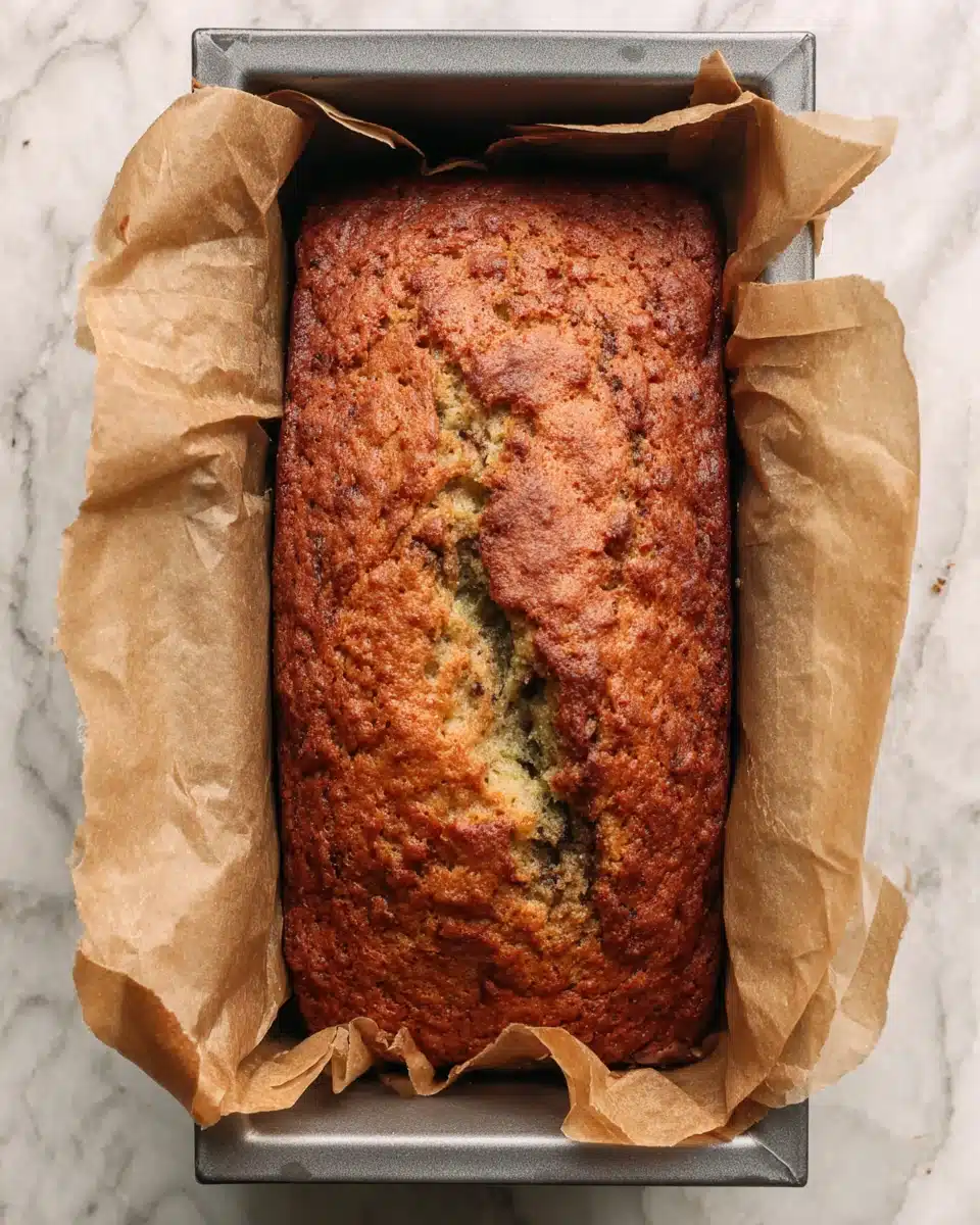 Matcha swirl banana bread in loaf pan with green swirls and golden crust