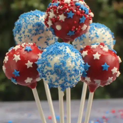Red, white, and blue patriotic cake pops with star shapes and sprinkles