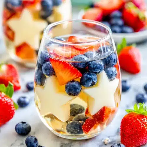 Delicious Patriotic Sangria You’ll Love! 1 Patriotic sangria with strawberries, blueberries, and star-shaped melon in a glass