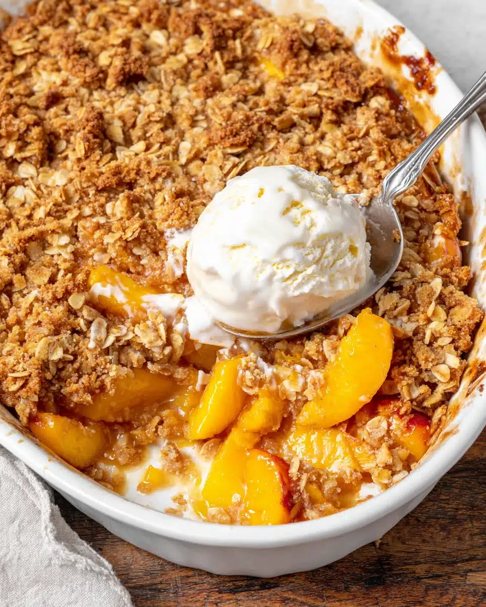 Peach crumble pie no crust with golden crumble topping and juicy peaches, served with ice cream