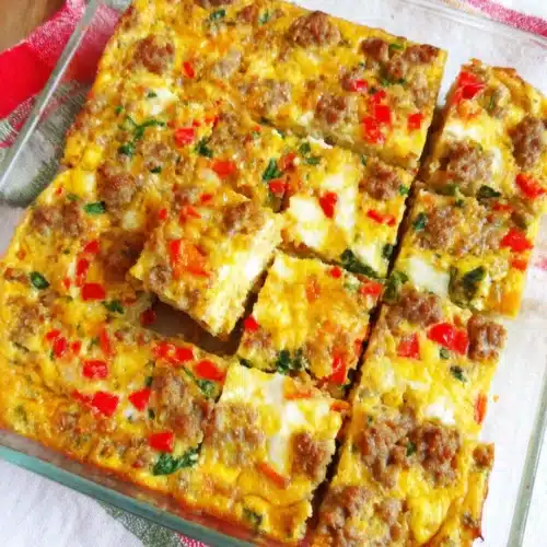 Sausage and egg Whole30 breakfast casserole in a glass dish, sliced and ready to serve
