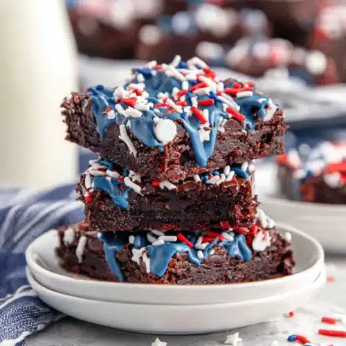 Star spangled brownies in star shapes with blue drizzle and red white blue sprinkles