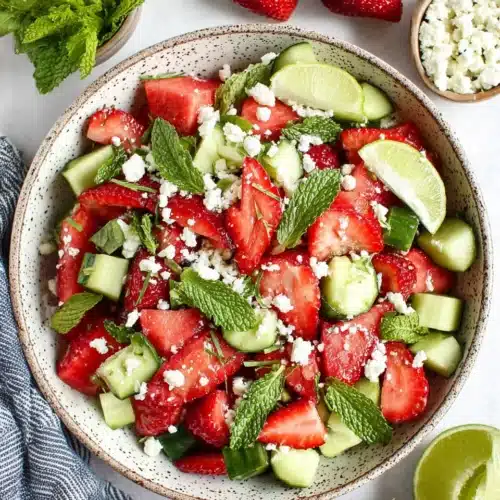 Strawberry watermelon cucumber salad with feta and mint in a ceramic bowl