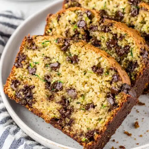 Tender Zucchini Bread with Melty Chocolate: Indulgent Delight 1 Tender zucchini bread with melty chocolate chips, sliced and served on a plate