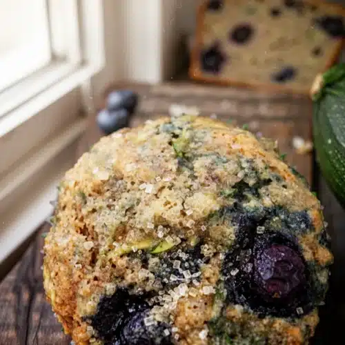 Blueberry banana zucchini bread muffins with fresh blueberries and shredded zucchini, topped with turbinado sugar