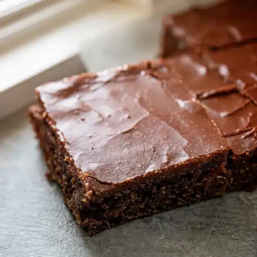 Chocolate Zucchini Sheet Cake: A Decadent Delight 2 Moist chocolate zucchini sheet cake with chocolate frosting, sliced and served