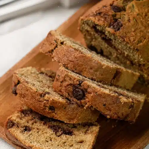 Gluten Free Zucchini Bread: Moist and Delicious 2 Slices of gluten free zucchini bread with chocolate chips on a wooden board